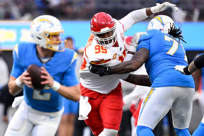 Chris Jones pushes past a Chargers player to try to sack the QB